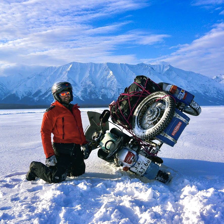 A sidecar motorcycle tipped over on the ice of Lake Baikal